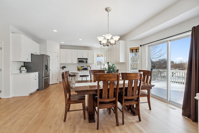 dining space featuring recessed lighting, light wood-style floors, visible vents, and a chandelier