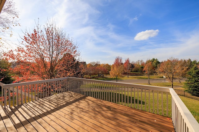 wooden deck featuring a yard