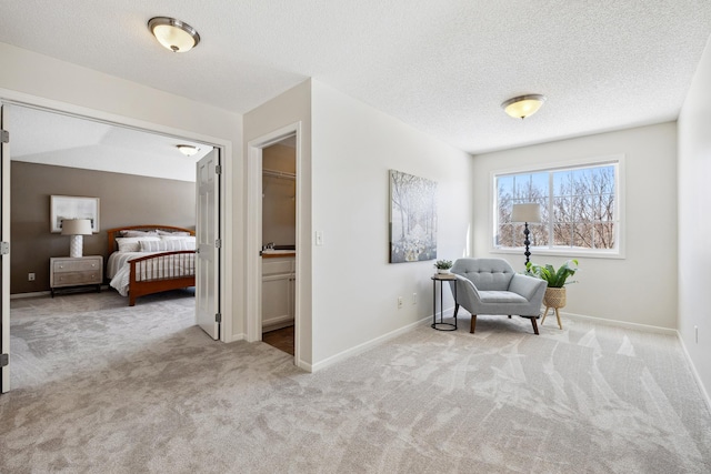 sitting room featuring a textured ceiling, baseboards, and carpet floors