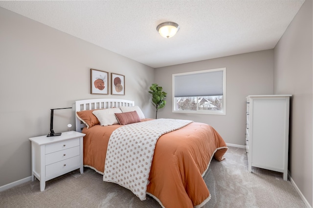 bedroom with baseboards, carpet, and a textured ceiling