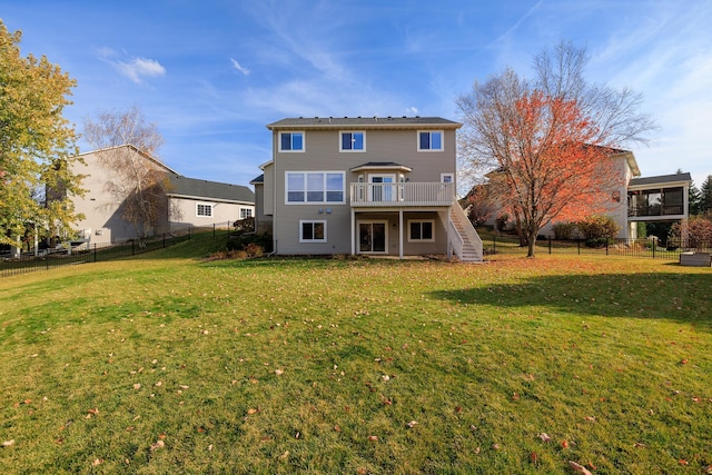 back of house featuring a yard, a fenced backyard, a wooden deck, and stairs