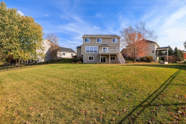 back of house with a yard, a deck, stairs, and fence