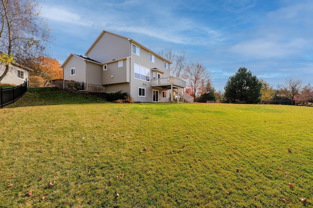 back of property featuring stairs, a yard, a fenced backyard, and a wooden deck