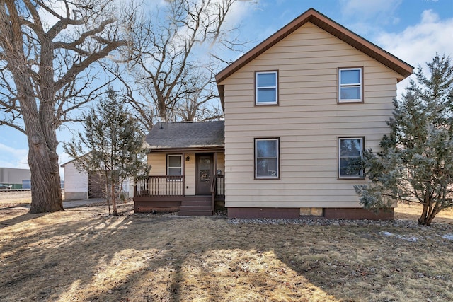 view of front of home featuring covered porch and a shingled roof