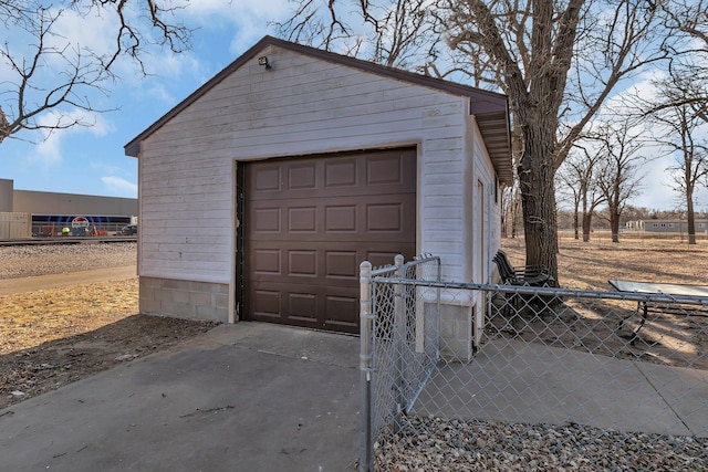 detached garage featuring fence