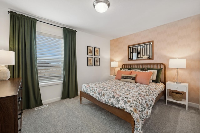 carpeted bedroom with visible vents, wallpapered walls, and baseboards