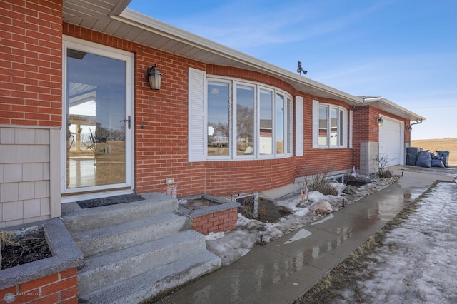 exterior space featuring brick siding and a garage