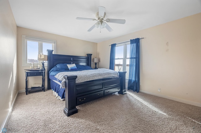 bedroom with a ceiling fan, baseboards, and carpet floors