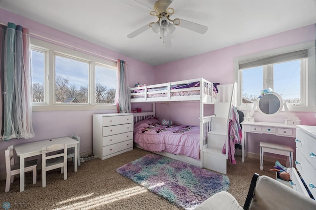 bedroom with carpet flooring, multiple windows, baseboards, and ceiling fan