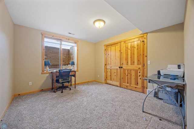 office space with baseboards, carpet floors, and visible vents