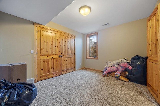 carpeted bedroom featuring visible vents and baseboards