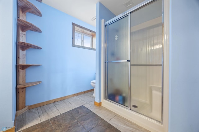 bathroom featuring visible vents, toilet, baseboards, and a stall shower