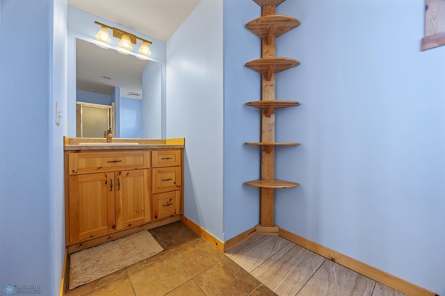 bathroom featuring vanity and baseboards