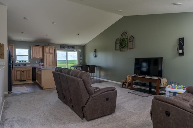 carpeted living area featuring vaulted ceiling and baseboards