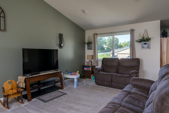 living room featuring carpet and vaulted ceiling