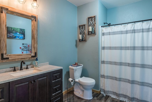 full bathroom with curtained shower, toilet, wood finished floors, and vanity