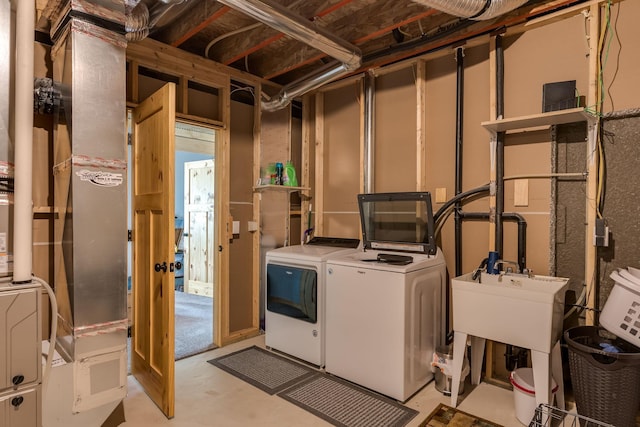 laundry room with a sink and separate washer and dryer