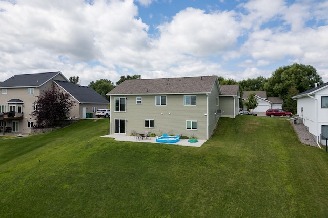 rear view of house with a patio area and a yard