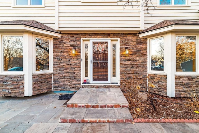 property entrance with stone siding