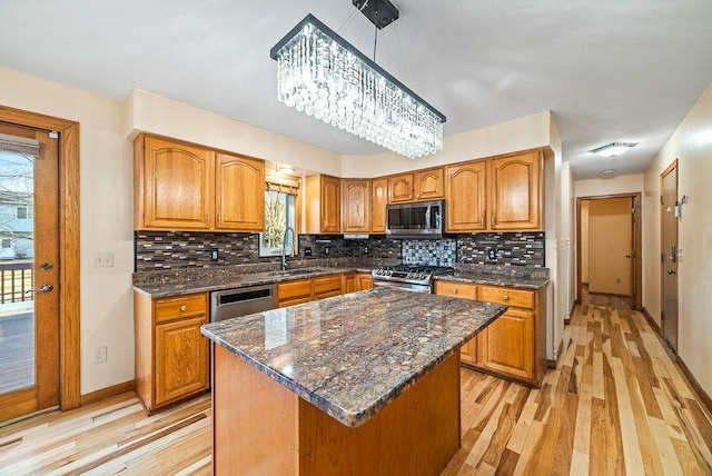 kitchen with visible vents, brown cabinets, appliances with stainless steel finishes, and a sink