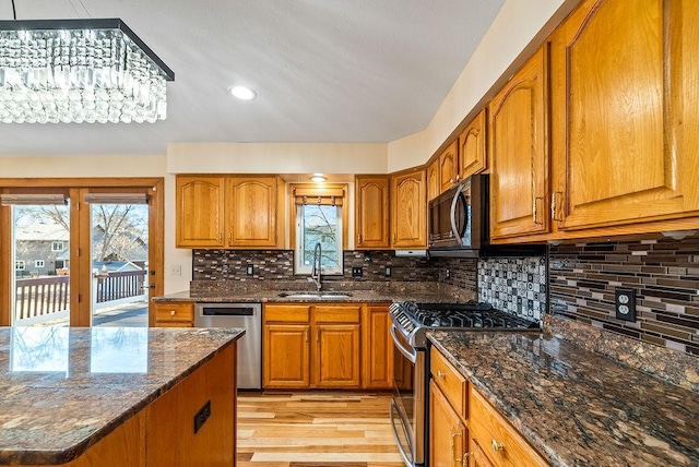 kitchen with brown cabinets, appliances with stainless steel finishes, and a sink