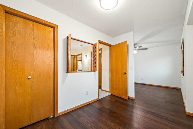 unfurnished bedroom featuring dark wood-style floors and baseboards