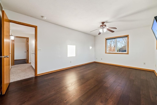 unfurnished room featuring a ceiling fan, visible vents, baseboards, and dark wood-style flooring