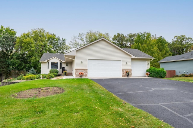 ranch-style house with a front yard, a garage, and aphalt driveway