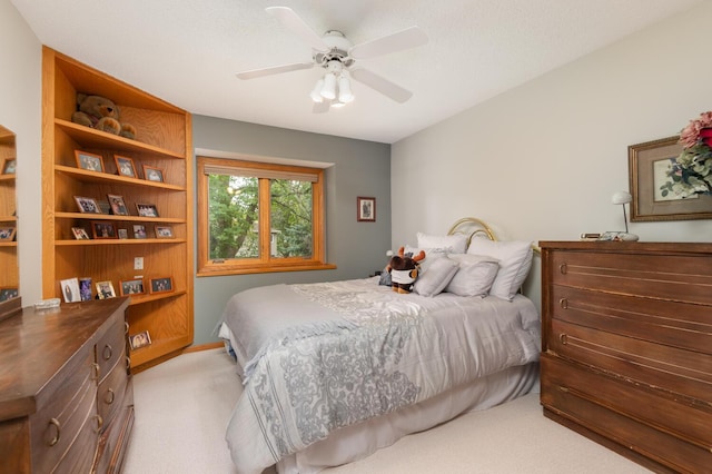 bedroom with a ceiling fan and light colored carpet