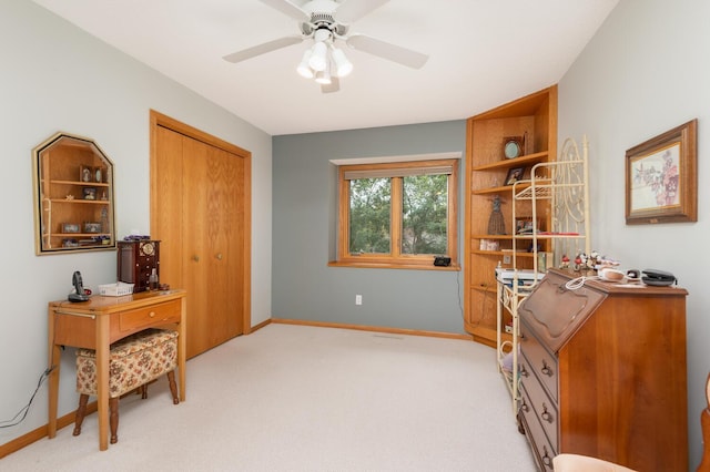 living area with light carpet, ceiling fan, and baseboards