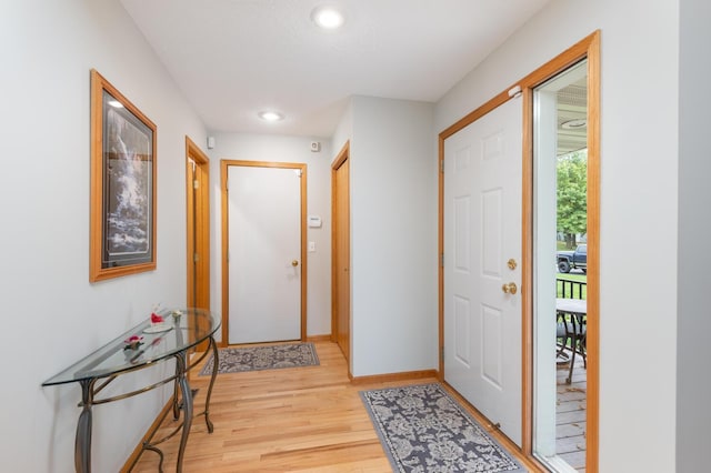 entryway with recessed lighting, baseboards, and light wood finished floors