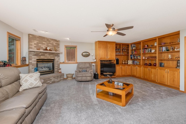 living area with light carpet, a brick fireplace, and a ceiling fan