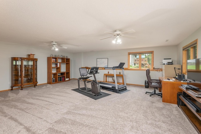 workout room with a ceiling fan, baseboards, and carpet floors