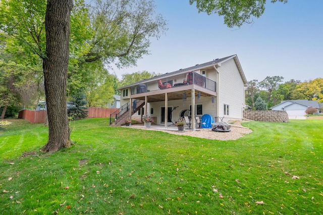 back of property featuring stairs, a patio, a yard, and a wooden deck