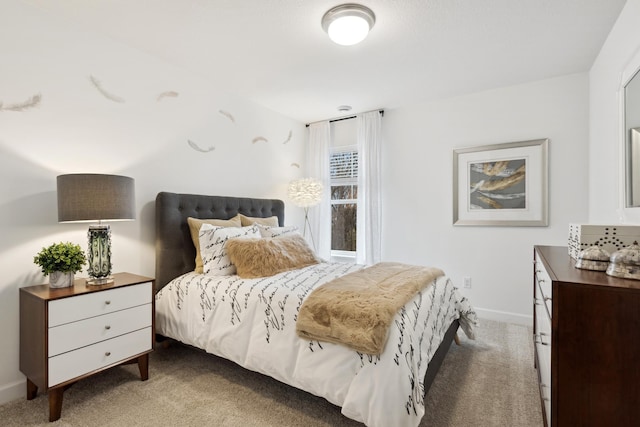 carpeted bedroom featuring baseboards