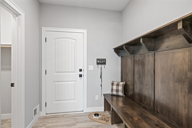 mudroom with visible vents, baseboards, and wood finished floors