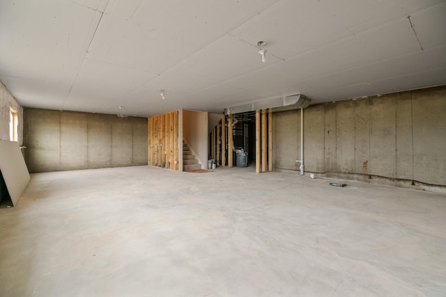 unfinished basement featuring stairs