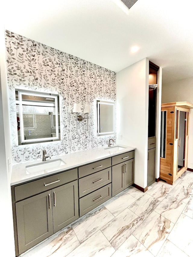 9551 230th St E, Lakeville, MN 55044 - bathroom featuring double vanity, wallpapered walls, and marble look tiles
