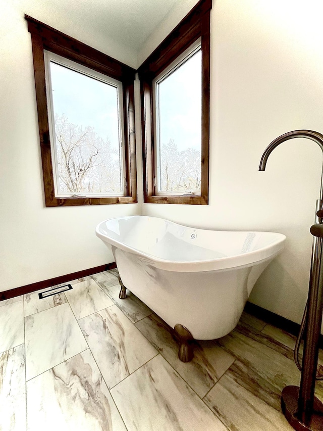 9551 230th St E, Lakeville, MN 55044 - bathroom with a freestanding tub and marble look tile flooring