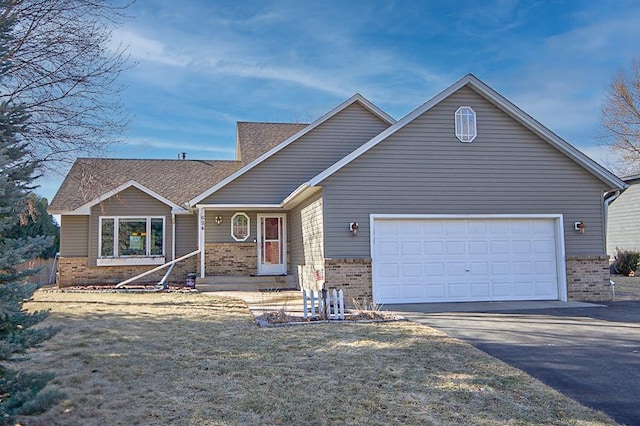ranch-style house featuring brick siding, an attached garage, a porch, and aphalt driveway