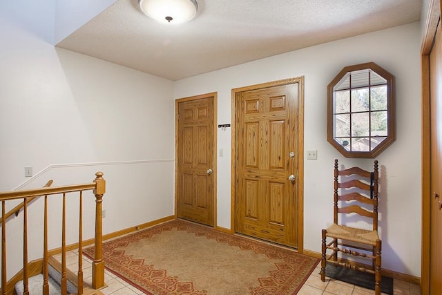 foyer with baseboards and light tile patterned floors
