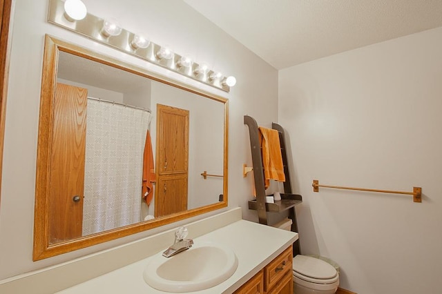 full bathroom featuring toilet and vanity