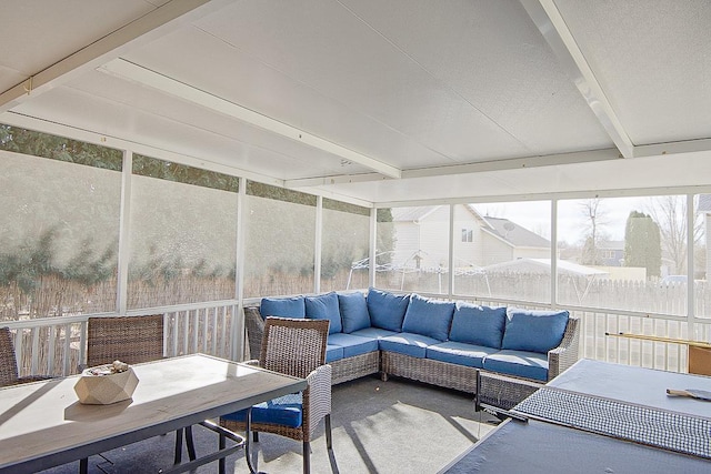 sunroom with outdoor lounge area and beam ceiling