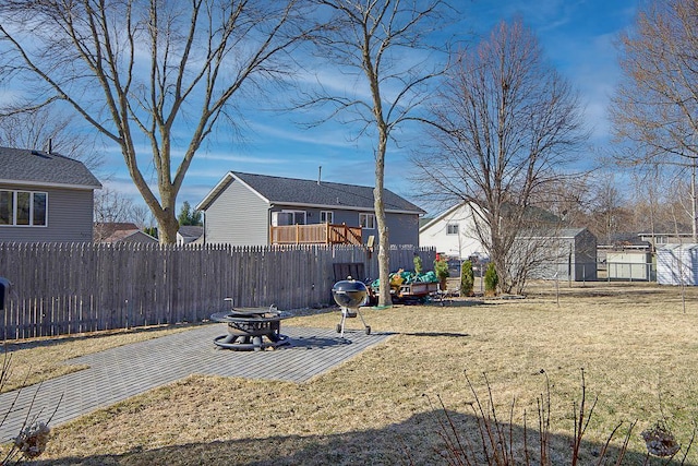 view of yard featuring a fire pit, a patio area, and fence
