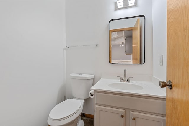 bathroom featuring toilet and vanity