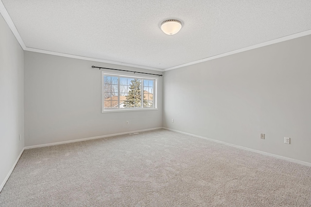 unfurnished room with crown molding, carpet, baseboards, and a textured ceiling