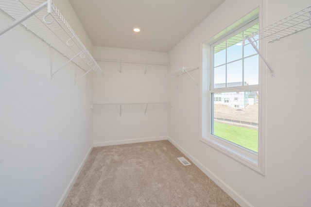 spacious closet with light carpet and visible vents