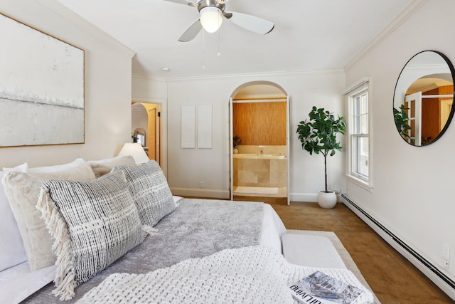 carpeted bedroom with ornamental molding, ensuite bath, arched walkways, a baseboard radiator, and baseboards