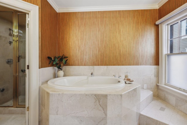 bathroom with a stall shower, a garden tub, and ornamental molding