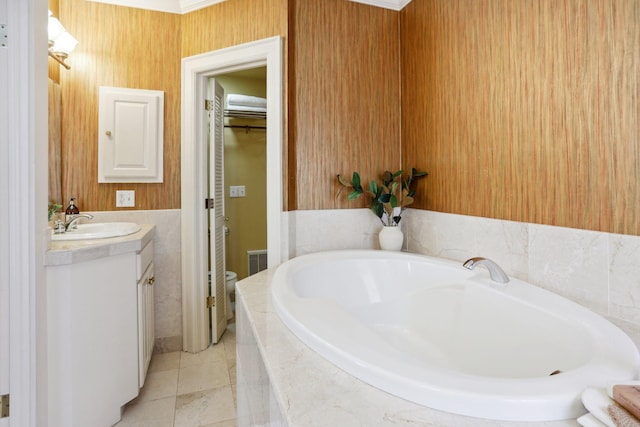 bathroom with a bath, visible vents, tile patterned flooring, and vanity